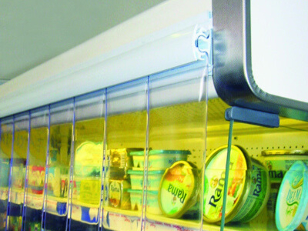 Close up of clear pvc strip curtains installed on a refrigerated dairy display.