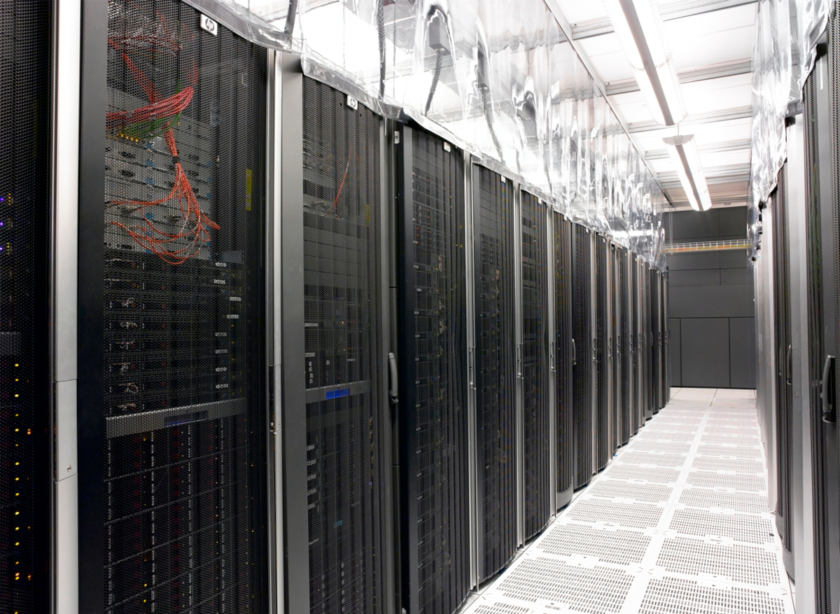 data center aisle with server racks and transparent pvc strip curtains for hot aisle containment